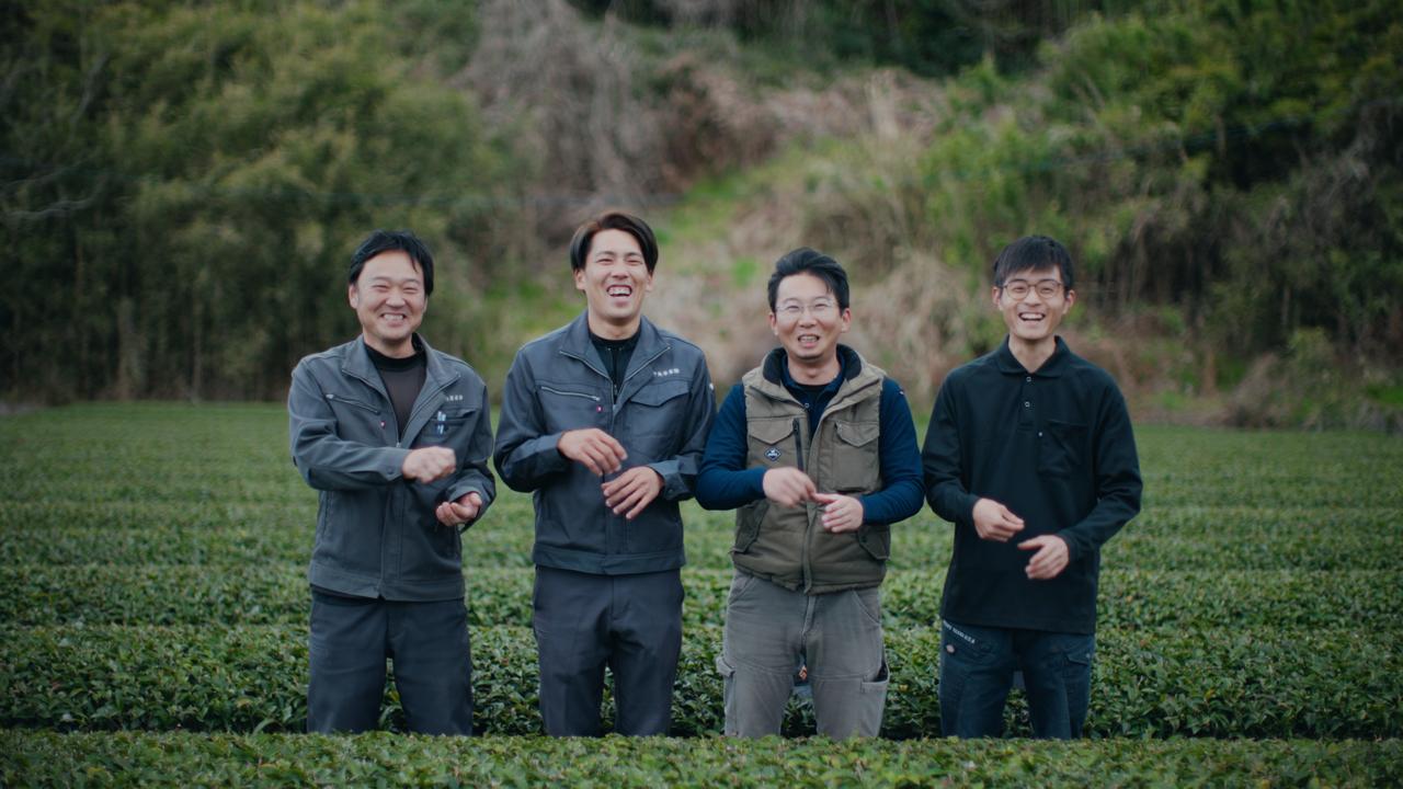 Four Sasaki Seicha field staff standing in a green tea field in Kakegawa, Shizuoka